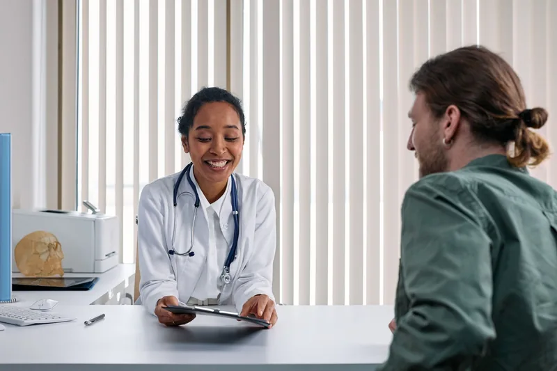Dr. Kapoor consulting with a patient